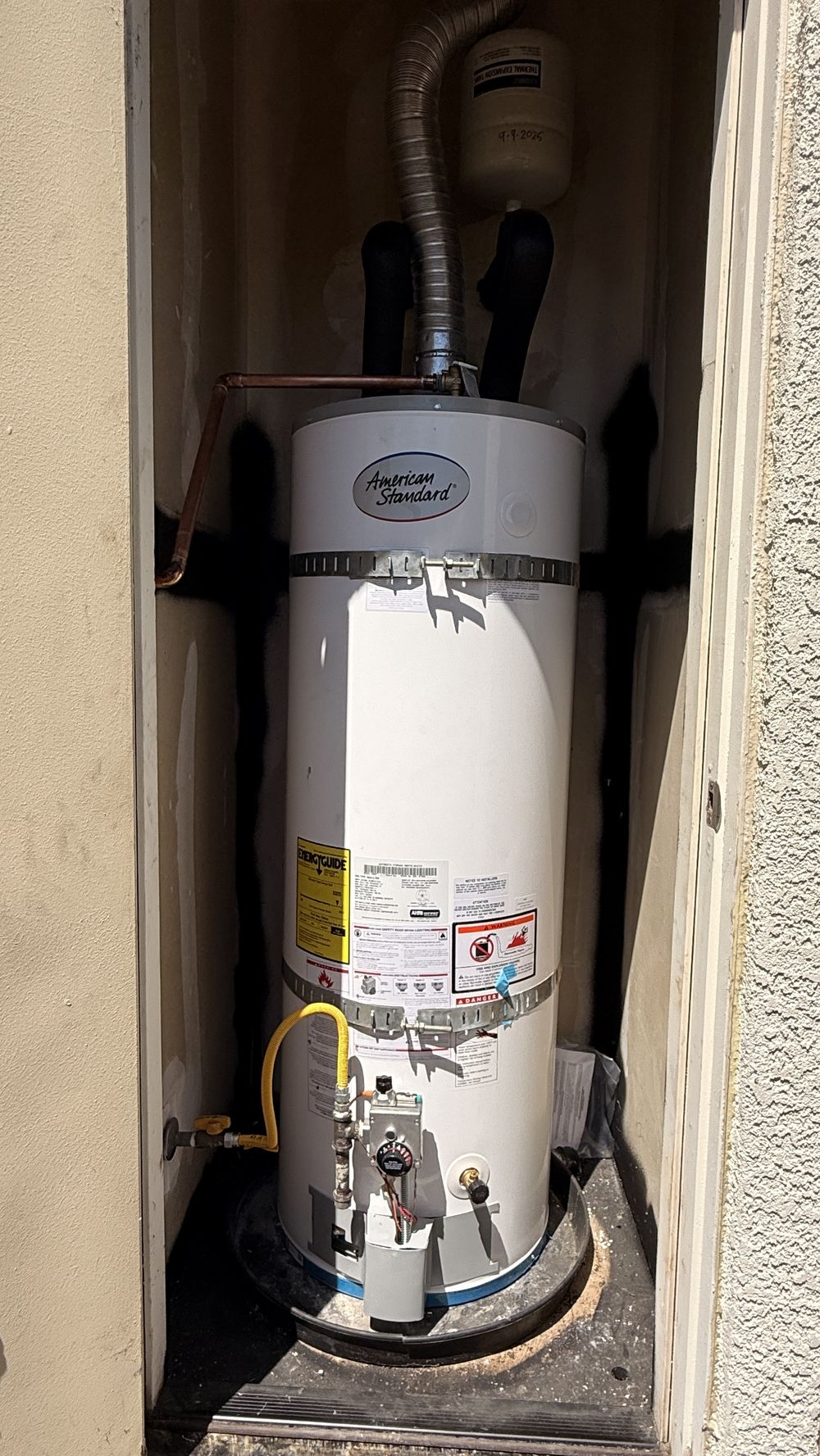 Newly installed water heater in a utility closet
